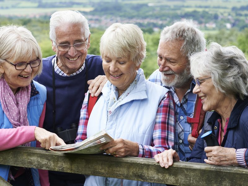 Group Of Senior Friends Hiking In Countryside